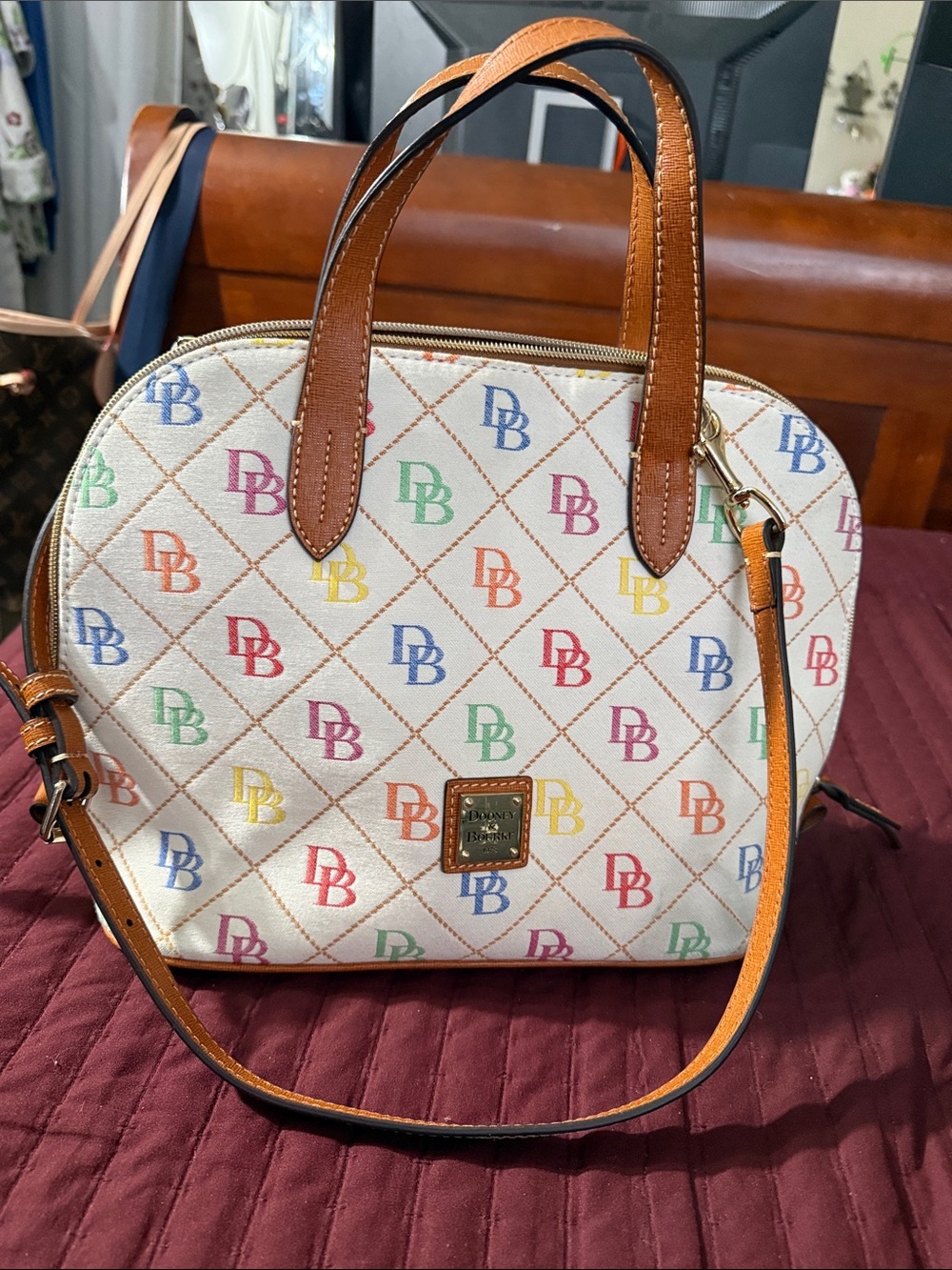 Dooney & Bourke Cream Satchel with Multicolor DB Logo and Brown Trim.